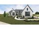 Elegant home featuring a bright white brick facade, complemented by a charming, professionally landscaped front yard at 1461 Chatham Ridge Ct, Westfield, IN 46074