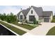 Elegant home featuring a bright white brick facade, complemented by a charming, professionally landscaped front yard at 1461 Chatham Ridge Ct, Westfield, IN 46074