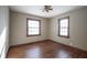 Simple bedroom with hardwood floors, ceiling fan, and two windows at 2209 Euclid Dr, Anderson, IN 46011