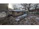 Tan house with snow covered yard, side view with shed and lake at 3 Lake Hart, Mooresville, IN 46158