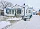 White ranch home with blue accents and a snow-covered yard at 3305 S New Jersey St, Indianapolis, IN 46227