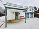 Two-car garage with covered entry and bench at 3305 S New Jersey St, Indianapolis, IN 46227