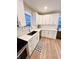 Renovated kitchen boasts white cabinets, quartz countertops, and herringbone tile backsplash at 3305 S New Jersey St, Indianapolis, IN 46227