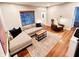 Spacious living room with sectional sofa, hardwood floors, and accent chair at 3305 S New Jersey St, Indianapolis, IN 46227