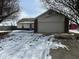 House exterior showcasing a garage and winter landscaping at 3371 Lauren Dr, Indianapolis, IN 46235