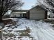 Brick ranch home with attached garage and snow-covered yard at 3371 Lauren Dr, Indianapolis, IN 46235
