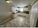 Eat-in kitchen with white cabinets and tile flooring at 3371 Lauren Dr, Indianapolis, IN 46235