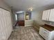 Kitchen area with white cabinets and view into living room at 3371 Lauren Dr, Indianapolis, IN 46235