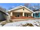 Charming bungalow with a brick front porch and tan siding at 3614 E New York St, Indianapolis, IN 46201