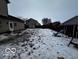 Snowy backyard with playground equipment and shed at 4651 Maplelawn Dr, Columbus, IN 47203