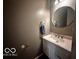 Small bathroom with white vanity and oval mirror at 4651 Maplelawn Dr, Columbus, IN 47203