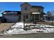 Two-story house with attached garage and covered porch. Landscaped yard with snowy patches at 4651 Maplelawn Dr, Columbus, IN 47203