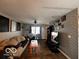 Living room with hardwood floors, wall-mounted TV, and cozy seating at 4651 Maplelawn Dr, Columbus, IN 47203