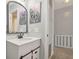 Bathroom boasts a white vanity, decorative mirror, and gray walls at 5152 Coppertree Ln, Avon, IN 46123