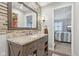 Bathroom boasts a large vanity, updated tile, and a view into bedroom at 5152 Coppertree Ln, Avon, IN 46123