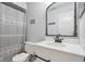 Updated bathroom with white vanity, gray shower curtain, and stylish mirror at 5152 Coppertree Ln, Avon, IN 46123