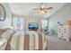 Bright bedroom featuring a large TV, comfortable bedding, and treetop views at 5152 Coppertree Ln, Avon, IN 46123