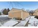 Tan colored detached garage with a snow covered walkway at 5152 Coppertree Ln, Avon, IN 46123