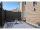 Small private patio with metal chairs and table, covered in snow at 5152 Coppertree Ln, Avon, IN 46123