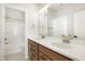Bathroom featuring a double vanity, with a large mirror and shower/tub combo in a separate room at 525 Gilder Dr, Carmel, IN 46032