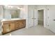 Bathroom featuring a double vanity, large mirror, and access to more rooms at 525 Gilder Dr, Carmel, IN 46032