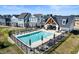 Community pool with lounge chairs and clubhouse surrounded by new homes in a planned neighborhood at 525 Gilder Dr, Carmel, IN 46032
