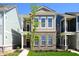 New construction townhome with brick and siding, manicured lawn, and walkway at 525 Gilder Dr, Carmel, IN 46032