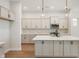 Modern kitchen featuring a center island, stainless steel appliances, and sleek gray cabinets at 525 Gilder Dr, Carmel, IN 46032