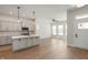 Open floor plan with hardwood flooring, kitchen island, and bright natural light at 525 Gilder Dr, Carmel, IN 46032