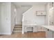 Open-concept space with stairs, built-in desk, and hardwood floors at 525 Gilder Dr, Carmel, IN 46032