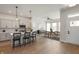 Open-concept living with hardwood floors, kitchen island, dining, and modern lighting at 525 Gilder Dr, Carmel, IN 46032