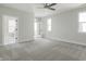 Spacious main bedroom with carpet, neutral paint, ceiling fan, and door to balcony at 525 Gilder Dr, Carmel, IN 46032