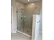 Luxurious walk-in shower with a glass door, rainfall showerhead, and tiled walls at 525 Gilder Dr, Carmel, IN 46032