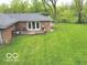 Exterior of the home with a walkout and a large grass filled backyard at 5420 Skyridge Dr, Indianapolis, IN 46250