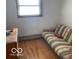 Small bedroom with hardwood floors and a futon at 5420 Skyridge Dr, Indianapolis, IN 46250
