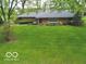 Charming single story home with mature landscaping and a well-manicured lawn at 5420 Skyridge Dr, Indianapolis, IN 46250