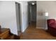 Hallway with hardwood floors and light gray walls at 5420 Skyridge Dr, Indianapolis, IN 46250