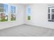 Bright bedroom with gray carpeting and large windows offering a view of the backyard at 5751 Cr W 750 N, McCordsville, IN 46055