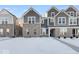 Two-story townhome with gray siding, white trim, and a snowy front yard at 5751 Cr W 750 N, McCordsville, IN 46055