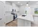 Modern white kitchen with island, stainless steel appliances, and bright windows at 5751 Cr W 750 N, McCordsville, IN 46055