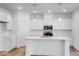 Modern white kitchen with center island and stainless steel appliances at 5751 Cr W 750 N, McCordsville, IN 46055