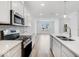 Modern kitchen with white cabinets and stainless steel appliances at 5755 Cr W 750 N, McCordsville, IN 46055