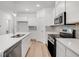 Modern kitchen with white cabinets, center island, and stainless steel appliances at 5755 Cr W 750 N, McCordsville, IN 46055