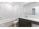 Clean bathroom with a white tub and dark vanity at 5763 Cr W 750 N, McCordsville, IN 46055