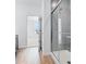 Bathroom with grey tile shower and hardwood floors at 5763 Cr W 750 N, McCordsville, IN 46055