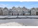 Three-story townhouses with gray siding, snow-covered yards, and charming front porches at 5763 Cr W 750 N, McCordsville, IN 46055