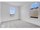 Bright bedroom with grey carpet and two large windows with neighborhood views at 5767 Cr W 750 N, McCordsville, IN 46055