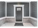 Gray front door with a brick base and white trim at 5767 Cr W 750 N, McCordsville, IN 46055