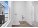 Laundry room with vinyl flooring, a large window, and a built in drain at 5767 Cr W 750 N, McCordsville, IN 46055