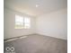 Neutral bedroom featuring a window, carpeted floor, and ample space at 6033 Granby Dr, Whitestown, IN 46075